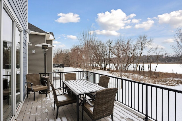 snow covered deck featuring outdoor dining space