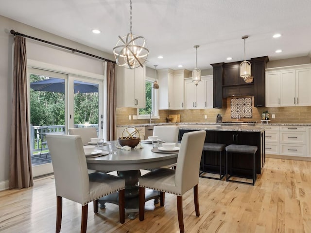 dining room with recessed lighting and light wood-type flooring