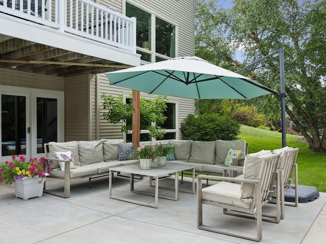 view of patio with outdoor lounge area and a balcony