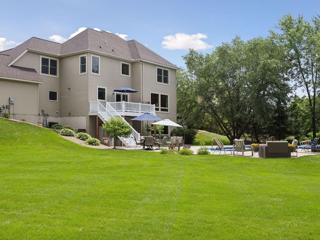 back of property with a patio area, stairway, a lawn, and outdoor lounge area