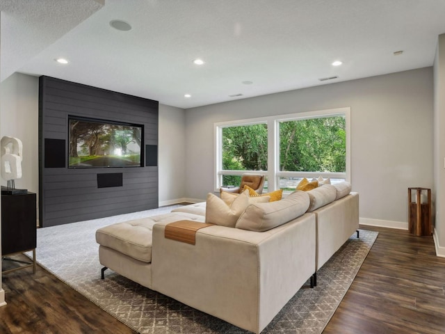 living room with dark wood finished floors, visible vents, recessed lighting, and baseboards