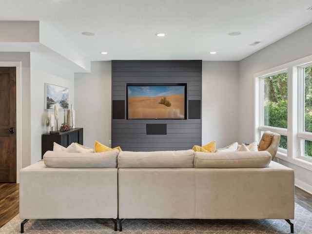 living room with recessed lighting, baseboards, plenty of natural light, and dark wood-style flooring