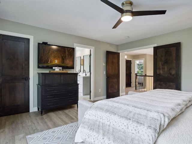 bedroom featuring baseboards, light wood-style flooring, and a ceiling fan