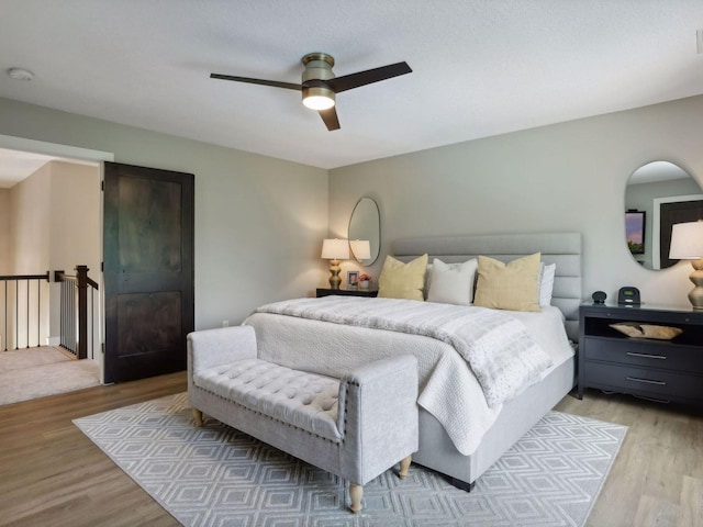 bedroom with ceiling fan and light wood-style floors