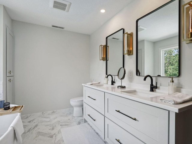 bathroom featuring a sink, visible vents, toilet, and marble finish floor