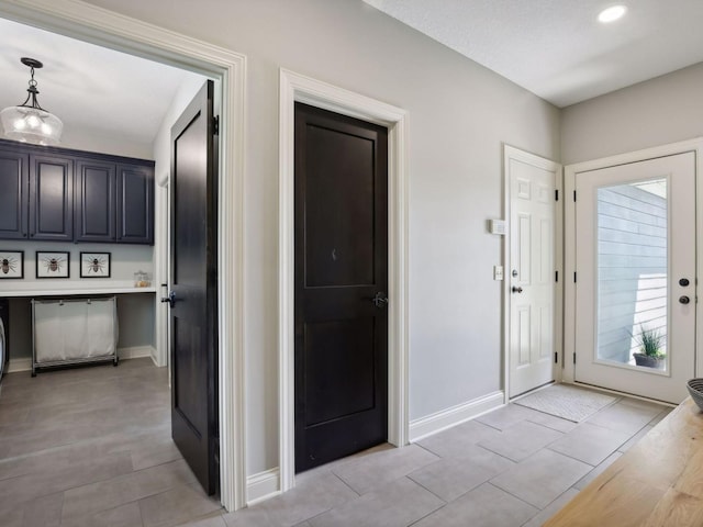 entryway featuring light tile patterned flooring and baseboards