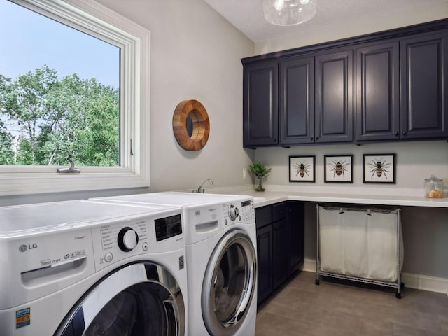 washroom with cabinet space and washer and dryer