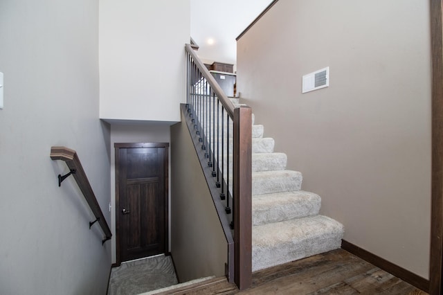 stairway featuring hardwood / wood-style floors