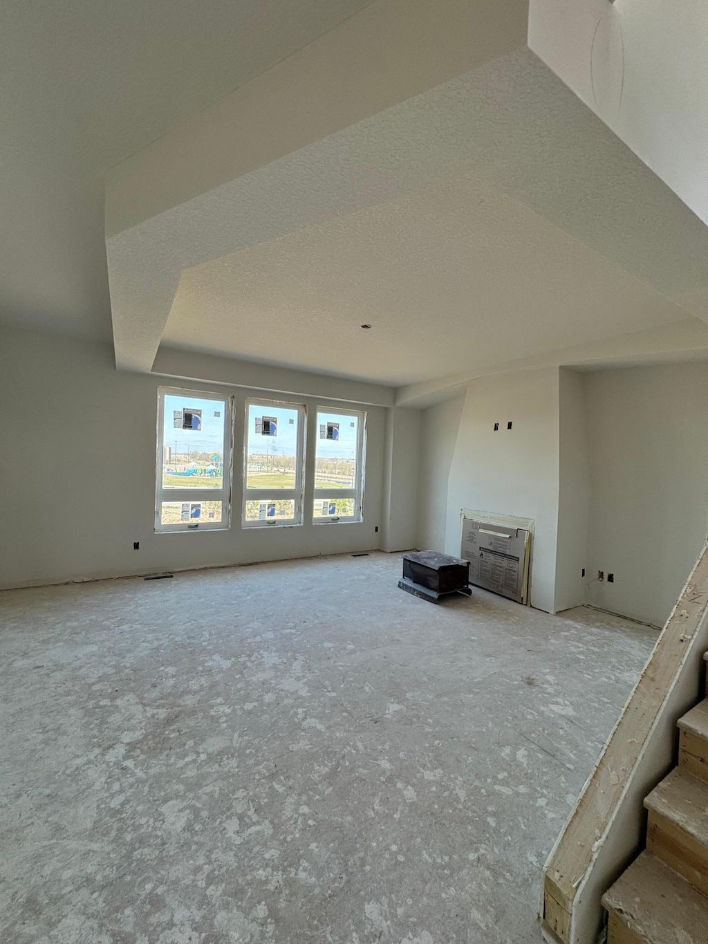 unfurnished living room with stairs and a fireplace