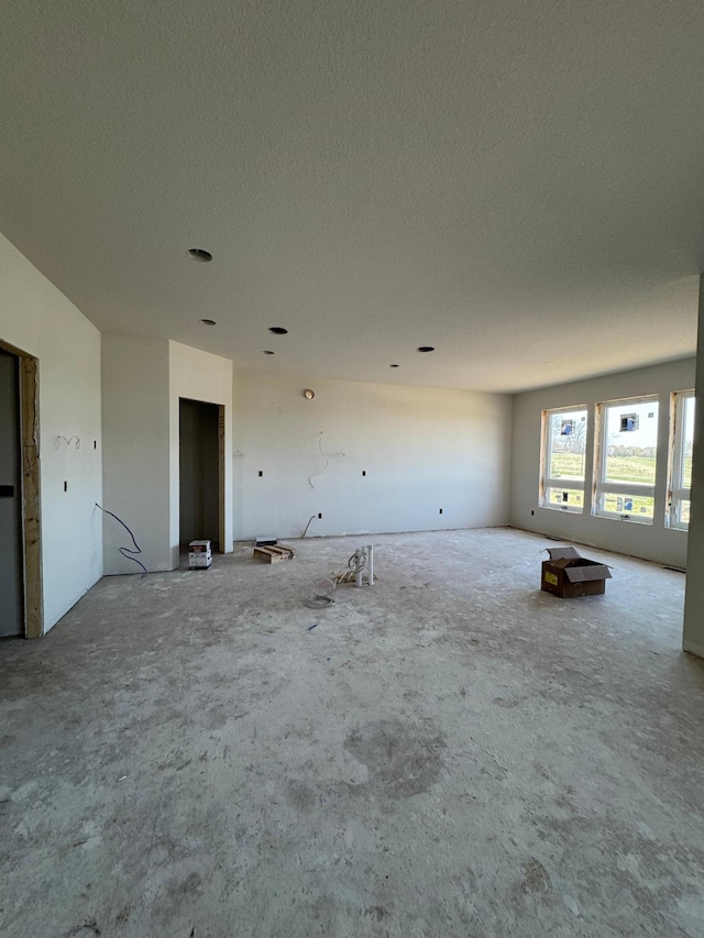spare room with a textured ceiling
