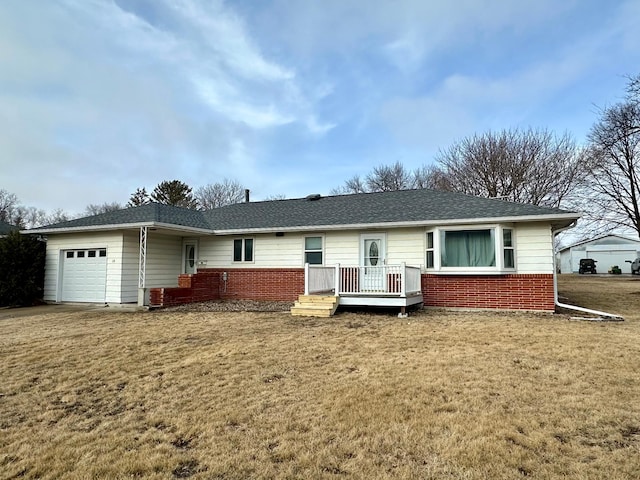 ranch-style home with a garage, a deck, and a front yard