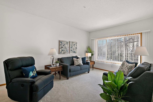 living area with light carpet, baseboards, and a textured ceiling