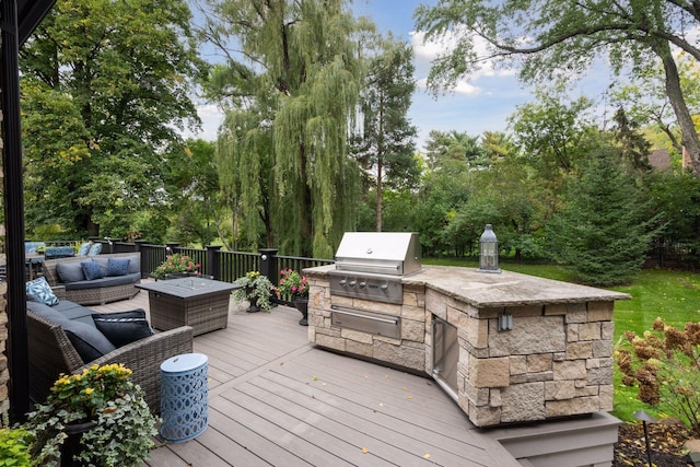 wooden terrace featuring area for grilling, a grill, and an outdoor hangout area