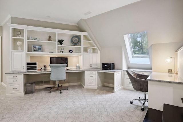 office area featuring crown molding, built in desk, and vaulted ceiling with skylight