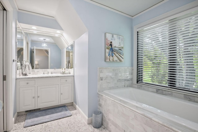 bathroom with ornamental molding, vanity, and tiled bath