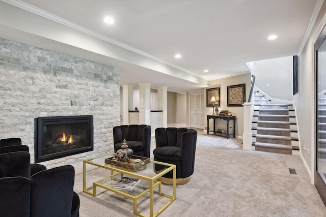 living room featuring ornamental molding, light colored carpet, and a fireplace