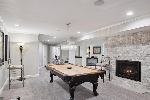 game room featuring billiards, ornamental molding, a stone fireplace, and light carpet