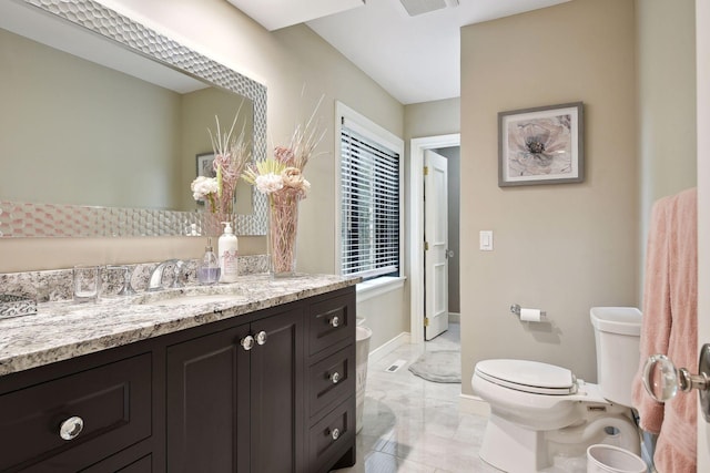 bathroom with vanity and toilet