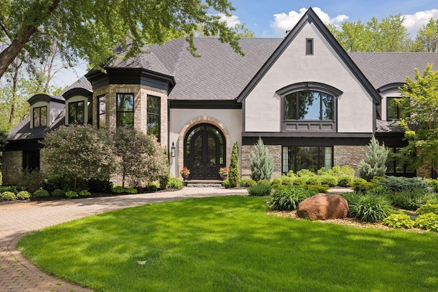 view of front facade featuring french doors and a front lawn