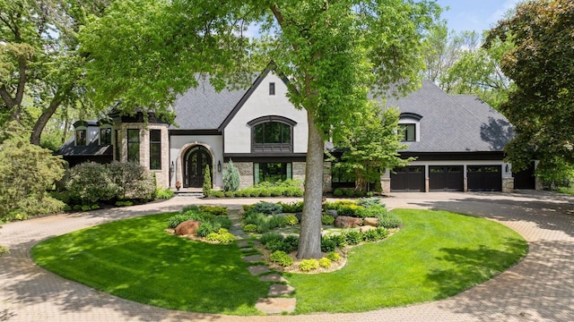 view of front of home featuring a garage and a front lawn