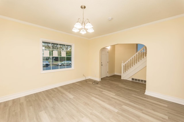 unfurnished room with an inviting chandelier, ornamental molding, and hardwood / wood-style floors