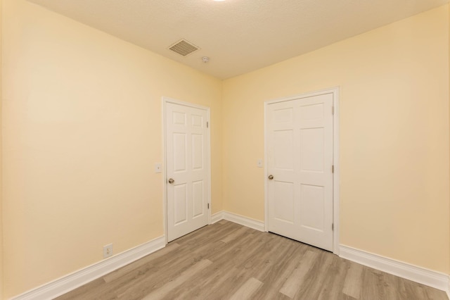 spare room featuring light hardwood / wood-style floors