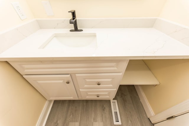 bathroom with hardwood / wood-style flooring and vanity