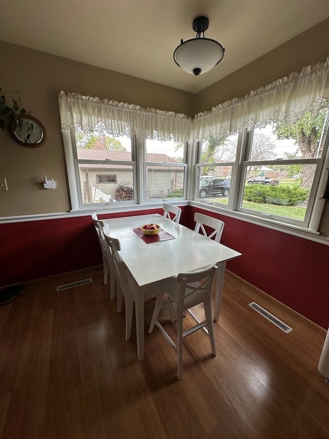 dining area featuring dark wood-type flooring