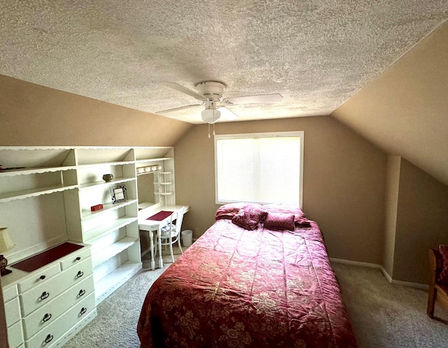 bedroom with ceiling fan, lofted ceiling, carpet floors, and a textured ceiling