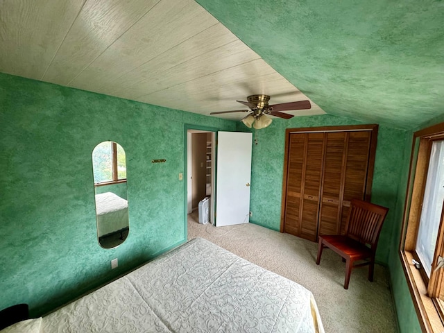 unfurnished bedroom with ceiling fan, lofted ceiling, and light carpet