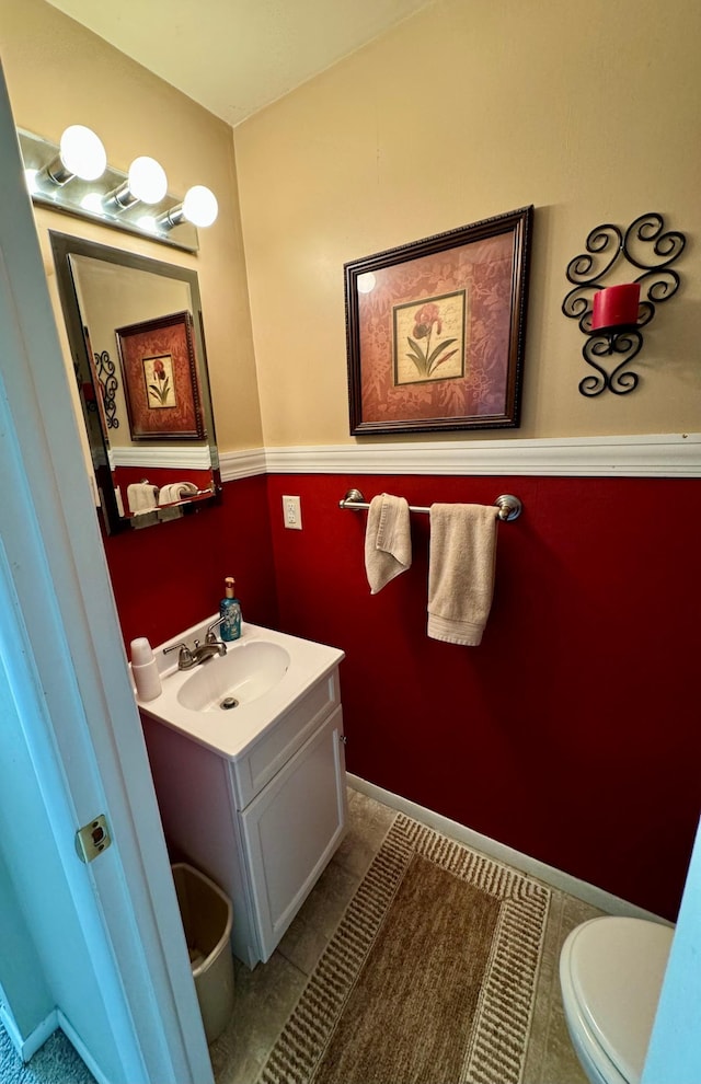 bathroom featuring tile patterned flooring, vanity, and toilet