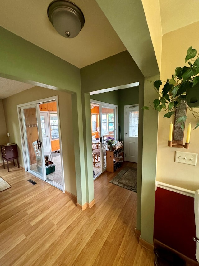 hall with light hardwood / wood-style flooring