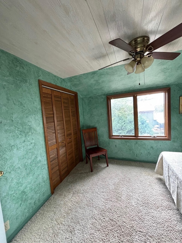 bedroom with a closet, ceiling fan, and carpet flooring