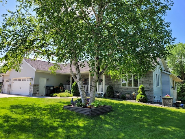 obstructed view of property featuring a garage, a front yard, and a porch