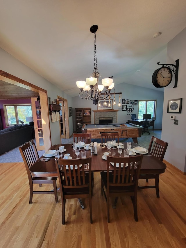 dining space with lofted ceiling and light hardwood / wood-style floors