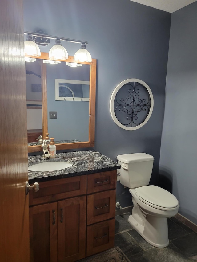 bathroom featuring vanity, tile patterned flooring, and toilet