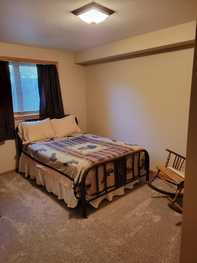 carpeted bedroom featuring a textured ceiling