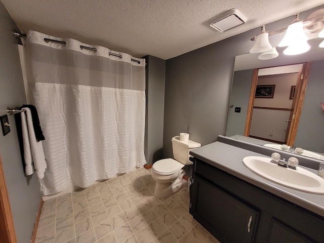 bathroom featuring vanity, a textured ceiling, toilet, and walk in shower