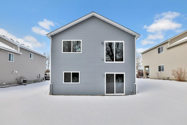 snow covered property featuring cooling unit