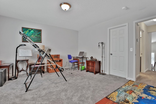 playroom with light colored carpet and a textured ceiling