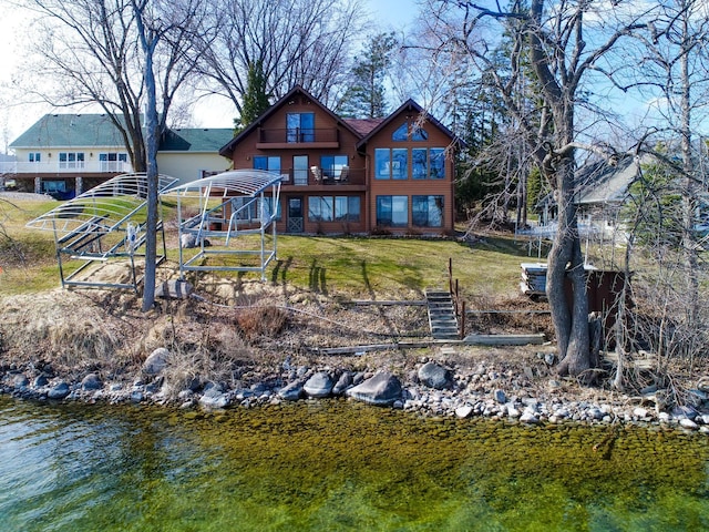 6451 Stardust Ln NE, Carlos Twp, MN 56308 - rear view of property featuring a lawn, a deck with water view, and stairway