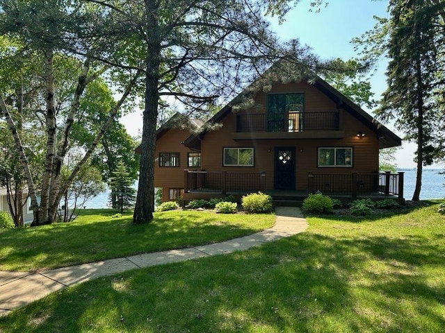 6451 Stardust Ln NE, Carlos Twp, MN 56308 - view of front facade featuring a balcony, a front yard, a water view, and covered porch