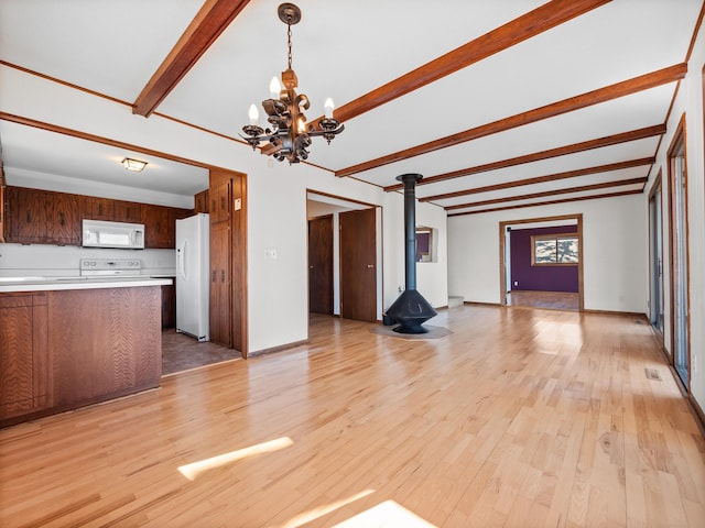 6451 Stardust Ln NE, Carlos Twp, MN 56308 - unfurnished living room with beamed ceiling, a chandelier, light wood finished floors, a wood stove, and baseboards