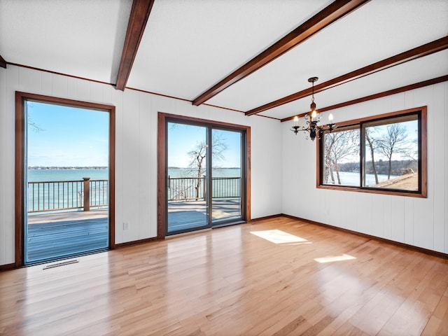 6451 Stardust Ln NE, Carlos Twp, MN 56308 - unfurnished room with beamed ceiling, a chandelier, light wood-type flooring, baseboards, and a water view