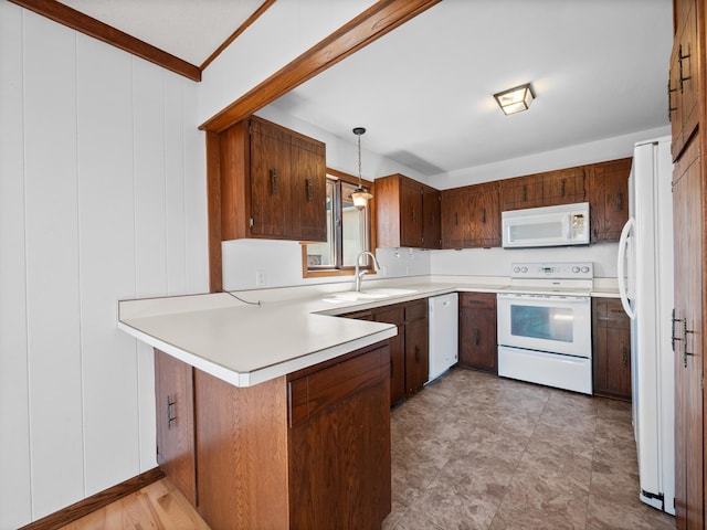 6451 Stardust Ln NE, Carlos Twp, MN 56308 - kitchen featuring white appliances, a peninsula, light countertops, a sink, and pendant lighting