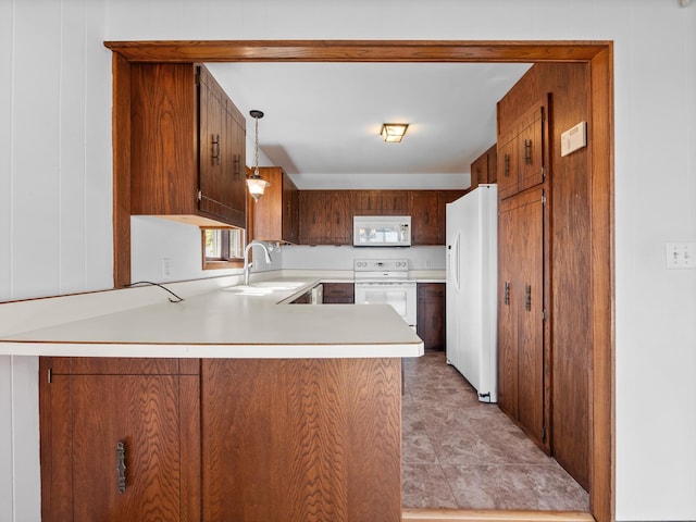 6451 Stardust Ln NE, Carlos Twp, MN 56308 - kitchen featuring white appliances, a sink, light countertops, a peninsula, and hanging light fixtures