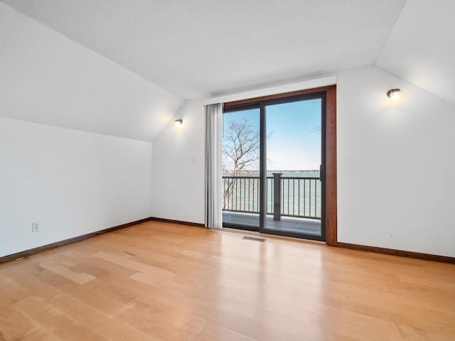 6451 Stardust Ln NE, Carlos Twp, MN 56308 - additional living space with vaulted ceiling, wood finished floors, and baseboards