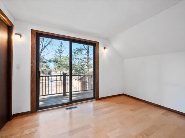 6451 Stardust Ln NE, Carlos Twp, MN 56308 - additional living space featuring light wood-style floors, baseboards, and vaulted ceiling