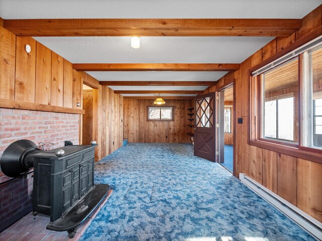 6451 Stardust Ln NE, Carlos Twp, MN 56308 - unfurnished living room with a baseboard radiator, beamed ceiling, wood walls, and carpet