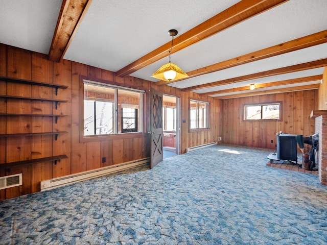 6451 Stardust Ln NE, Carlos Twp, MN 56308 - unfurnished living room featuring a baseboard radiator, a wood stove, carpet, wooden walls, and beam ceiling